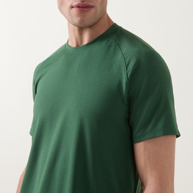 Model wearing Lululemon License to Train Short-Sleeve T-Shirt in Green Cove, close-up view of crew neck and short raglan sleeves.