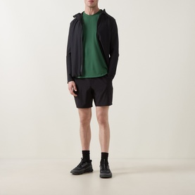 Model wearing Lululemon License to Train Short-Sleeve T-Shirt in Green Cove, styled with black zip hoodie, shorts, and trainers.