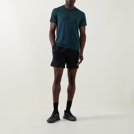 Model wearing Lululemon Metal Vent Tech Short-Sleeve T-Shirt in Green Cove/Club Blue, styled with black shorts and dark trainers.