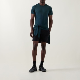 Model wearing Lululemon Metal Vent Tech Short-Sleeve T-Shirt in Green Cove/Club Blue, styled with black shorts and black trainers.