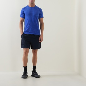 Model wearing Lululemon Metal Vent Tech Short-Sleeve T-Shirt in Ocean Wave/Beach Ball Blue, styled with navy shorts and black trainers.