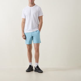 Model wearing Lululemon white T-shirt with light blue shorts and black trainers