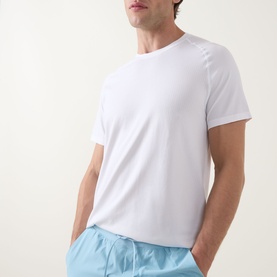 Model wearing Lululemon white performance T-shirt with light blue shorts, crew neck, short sleeves, relaxed fit.