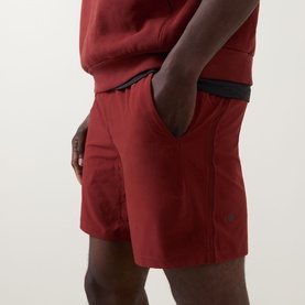 Model wearing Lululemon Cranberry Charm performance shorts with black waistband detail, styled with matching sweatshirt.