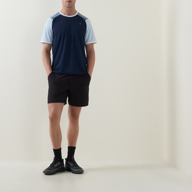 Model wearing Lululemon UV-Protective Textured Mesh Tennis Shirt in Club Blue/Steel Blue, styled with black shorts and black trainers