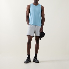 Model wearing Lululemon Seafoam sleeveless performance vest with grey shorts, black cap and black trainers.