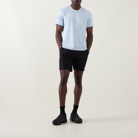Model wearing Lululemon Starch Blue T-shirt with black shorts, black socks and chunky black trainers