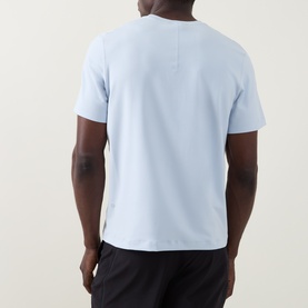 Model wearing Lululemon Starch Blue T-shirt, back view, with black shorts.
