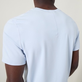 Model wearing Lululemon Starch Blue T-shirt, back view showing clean seam detail and short sleeves.
