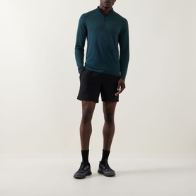 Model wearing Lululemon Metal Vent Short Sleeve T-Shirt in Green Cove/Club Blue, styled with black shorts, socks, and trainers.