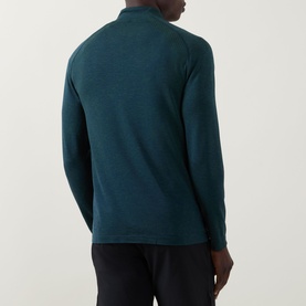 Model wearing Lululemon Metal Vent Short Sleeve T-Shirt in Green Cove/Club Blue, shown from behind, styled with dark trousers.