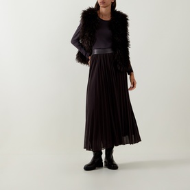 Model wearing Tuzzi Dark Chocolate shirt with pleated midi skirt, faux fur gilet and black ankle boots.