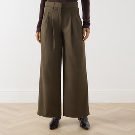 Model wearing Vivere Olive Green wide-leg trousers with front pleats, styled with black leather loafers and a dark burgundy top.