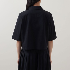 Model wearing Marc O Polo Woven Cropped Blouse in black, rear view, showing notch lapel collar, half-length sleeves and straight hem, styled with