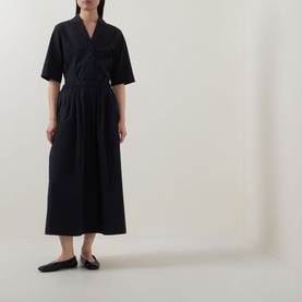 Model wearing Marc O Polo Woven Cropped Blouse in black with notch lapel, half-length sleeves, styled with wide-leg trousers and black flat shoes