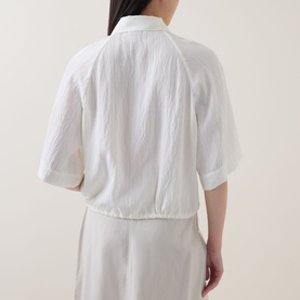 Model wearing Marc O Polo Textured Drawstring Blouse in white, showing crinkle texture, half-length sleeves and drawstring hem, back view