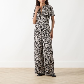 Model wearing Marc O Polo Floral Fluid Blouse in black multi with wide-leg floral trousers and black shoes.