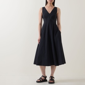Model wearing Marc O Polo Woven Flared Dress in black, V-neck sleeveless midi with full skirt, styled with black strappy sandals