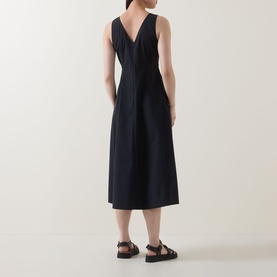Model wearing Marc O Polo Woven Flared Dress in black, showing V-back, sleeveless midi silhouette with flared skirt and rear zip detail
