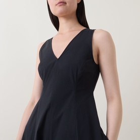 Model wearing Marc O Polo Woven Flared Dress in black, featuring a V-neckline, sleeveless silhouette and fitted waist with flared skirt.