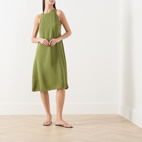 Model wearing Marc O Polo Dress in Shaded Fern, sleeveless halterneck, midi length, styled with tan flat sandals