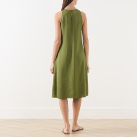 Model wearing Marc O Polo Dress in Shaded Fern, sleeveless midi length with round neckline, paired with tan flat sandals, back view.