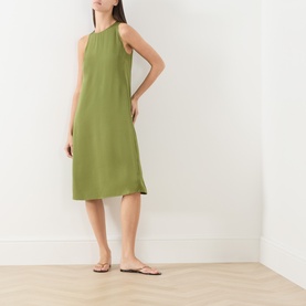 Model wearing Marc O Polo Dress in Shaded Fern, sleeveless halterneck midi style in viscose, styled with tan flat sandals.