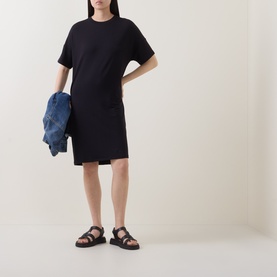 Model wearing Marc O Polo Solid Sweatshirt Dress in black, short sleeves, straight hem mini length, styled with black chunky sandals, carrying denim