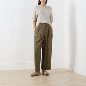 Model wearing Marc O Polo Linen Beige knit top, styled with olive wide-leg trousers and beige loafers.