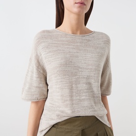 Model wearing Marc O Polo Linen Beige linen-cotton knit top with elbow-length sleeves and round neck, styled with olive trousers.