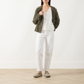 Model wearing Marc O Polo White Cotton knit top with olive jacket, white trousers and taupe loafers