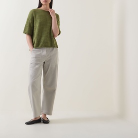 Model wearing Marc O Polo Shaded Fern linen-cotton knit top with short sleeves, styled with stone tapered trousers and black flats.