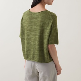 Model wearing Marc O Polo Shaded Fern linen-cotton knit top, boxy short-sleeve silhouette, back view, styled with light grey trousers.