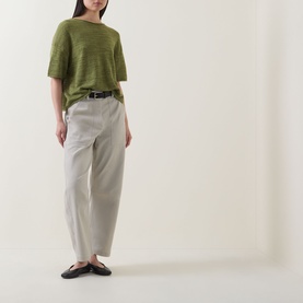 Model wearing Marc O Polo Shaded Fern linen-cotton knit top with stone wide-leg trousers, belt and black flat shoes.