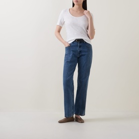 Model wearing Marc O Polo Solid Slub T-Shirt in White Cotton with scoop neck and short sleeves, styled with straight-leg blue jeans and taupe loafers.