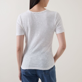 Model wearing Marc O Polo Solid Slub T-Shirt in White Cotton, scoop back, short sleeves, straight hem, styled with blue jeans
