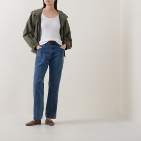 Model wearing Marc O Polo Solid Slub T-Shirt in White Cotton with scoop neck, styled with khaki jacket, blue straight-leg jeans and brown loafers