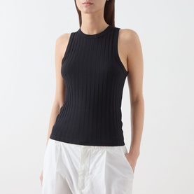 Model wearing Marc O Polo black ribbed sleeveless top with high neck, styled with white wide-leg trousers.