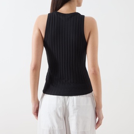 Model wearing Marc O Polo black ribbed sleeveless knit top, rear view, styled with white wide-leg trousers.