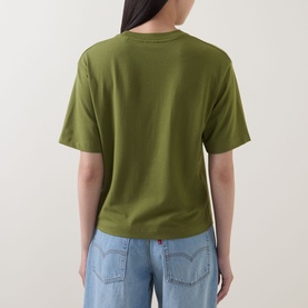 Model wearing Marc O Polo Solid Relaxed T-Shirt in Shaded Fern, back view, short sleeves, straight hem, styled with light blue jeans.