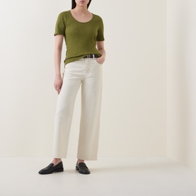 Model wearing Marc O Polo Solid Slub T-Shirt in Shaded Fern with scoop neck, styled with cream wide-leg trousers and black loafers.