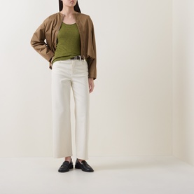 Model wearing Marc O Polo Solid Slub T-Shirt in Shaded Fern with scoop neck, styled with cream wide-leg trousers, camel cardigan and black loafers