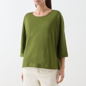 Model wearing Marc O Polo Shaded Fern cotton T-shirt with three-quarter sleeves and relaxed boxy fit, styled with cream trousers.