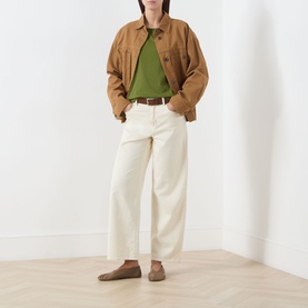 Model wearing Marc O Polo Shaded Fern cotton T-shirt, styled with tan jacket, cream wide-leg trousers and brown loafers.