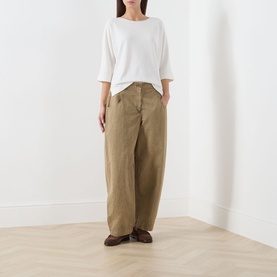 Model wearing Marc O Polo white cotton T-shirt with bateau neckline and three-quarter sleeves, styled with wide-leg khaki trousers and brown loafers.