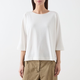 Model wearing Marc O Polo White Cotton T-Shirt with cropped boxy fit and three-quarter sleeves, styled with khaki trousers