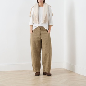 Model wearing Marc O Polo White Cotton T-Shirt, styled with wide-leg tan trousers, cream scarf vest and brown loafers.