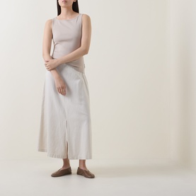 Model wearing Marc O Polo Linen Beige cotton tank top, styled with a cream midi skirt and tan flat mules.