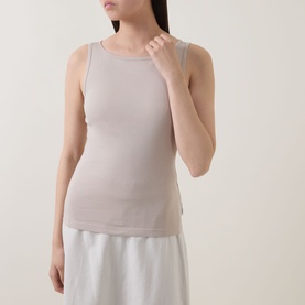 Model wearing Marc O Polo Linen Beige cotton sleeveless vest top with round neck, styled with a white skirt.