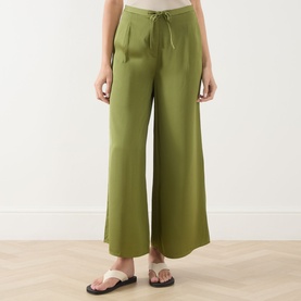 Model wearing Marc O Polo Shaded Fern wide-leg drawstring trousers in viscose, styled with tan flat sandals.